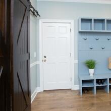 The Oaks - pale gray mudroom with barn door