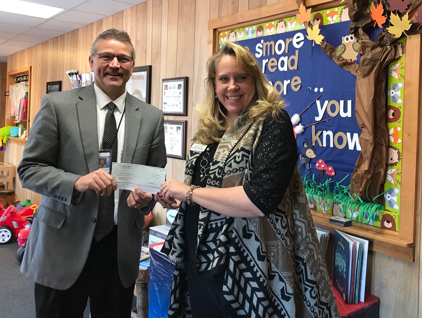 Pictured (left) is Ellis Ayers, ACF board member, presenting a grant award to Jennifer Simpson, executive director of the Blue Ridge Partnership for Children.