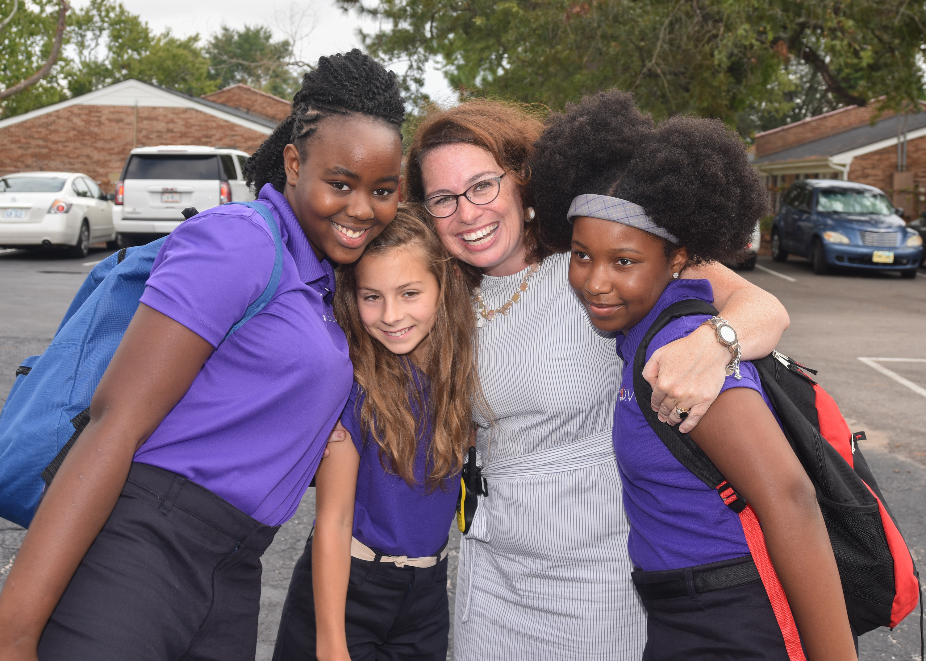 Three GLOW Academy students pose for a photo with Principal Laura Hunter, pictured middle right.