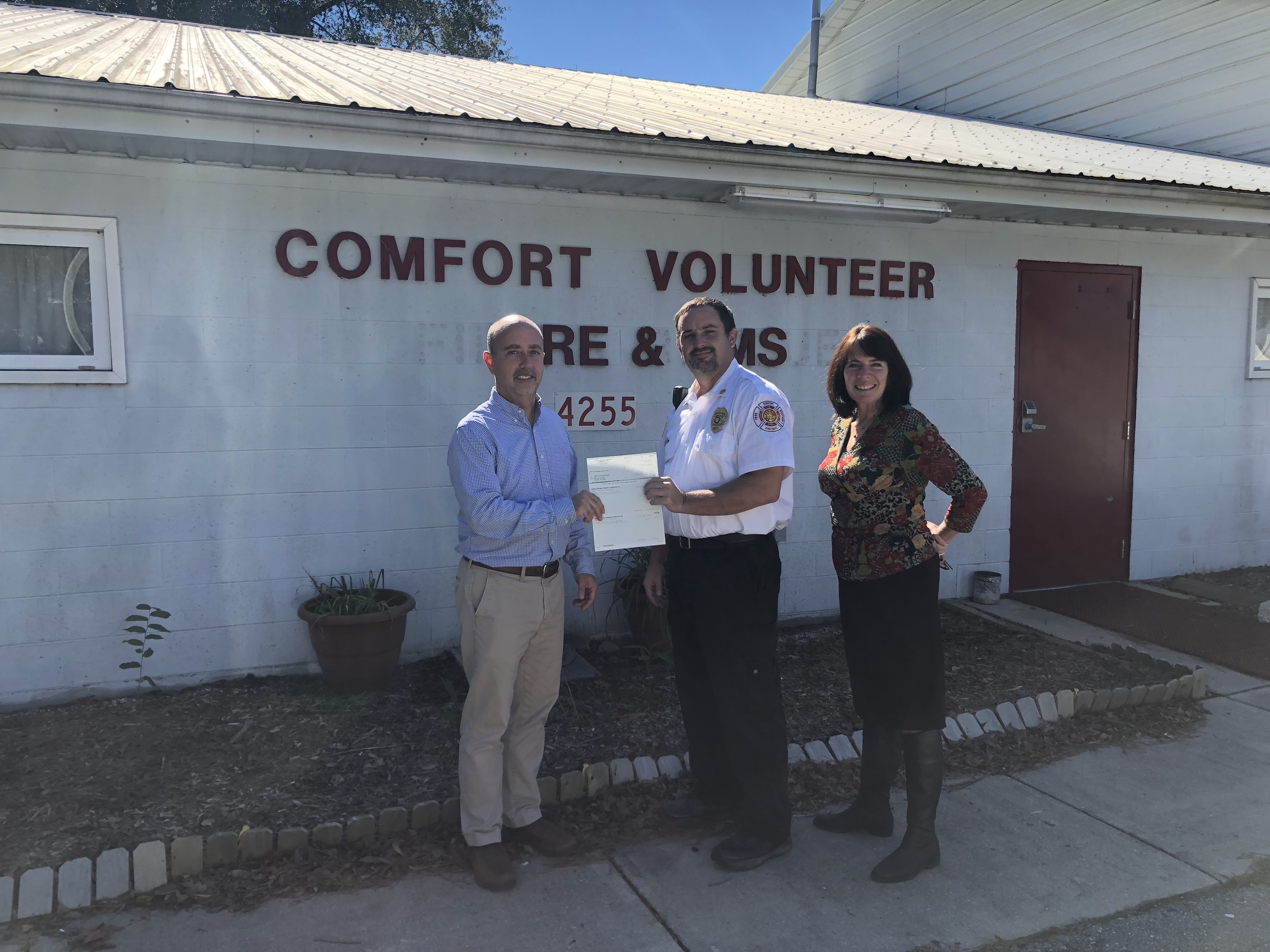 Charley Jones, JCCF president, presents a grant award to Comfort Fire Department for an AED (defibrillator) equipment update.