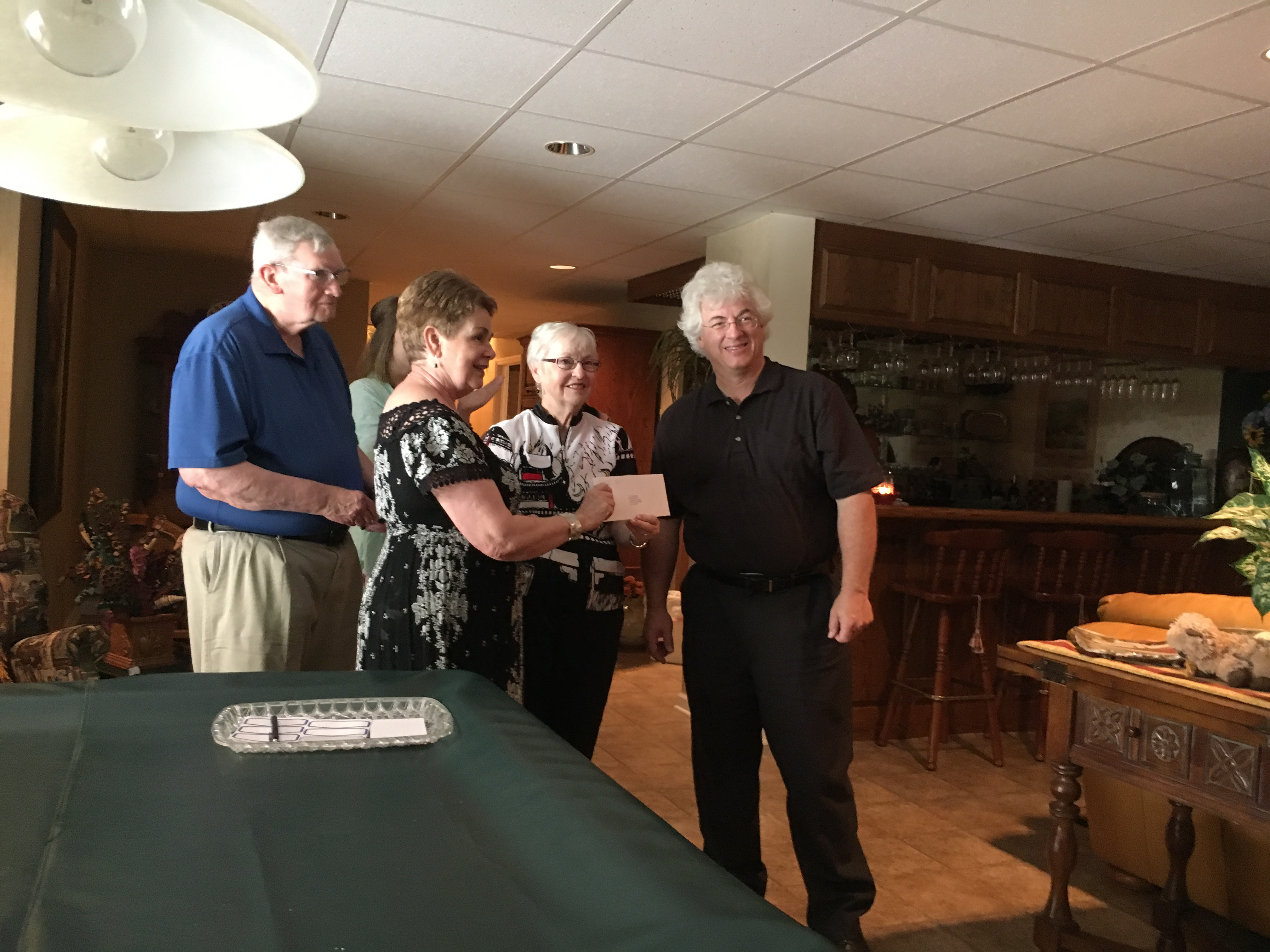 Sharon Matheny, president of the Montgomery County Fund, presents a grant check to Paul Chandley, director of the Trinity Music Academy, and Deloris Lassiter, president of the Trinity Music Academy board. Also pictured: Jim Matheny. The grant will fund scholarships for children's music lessons.