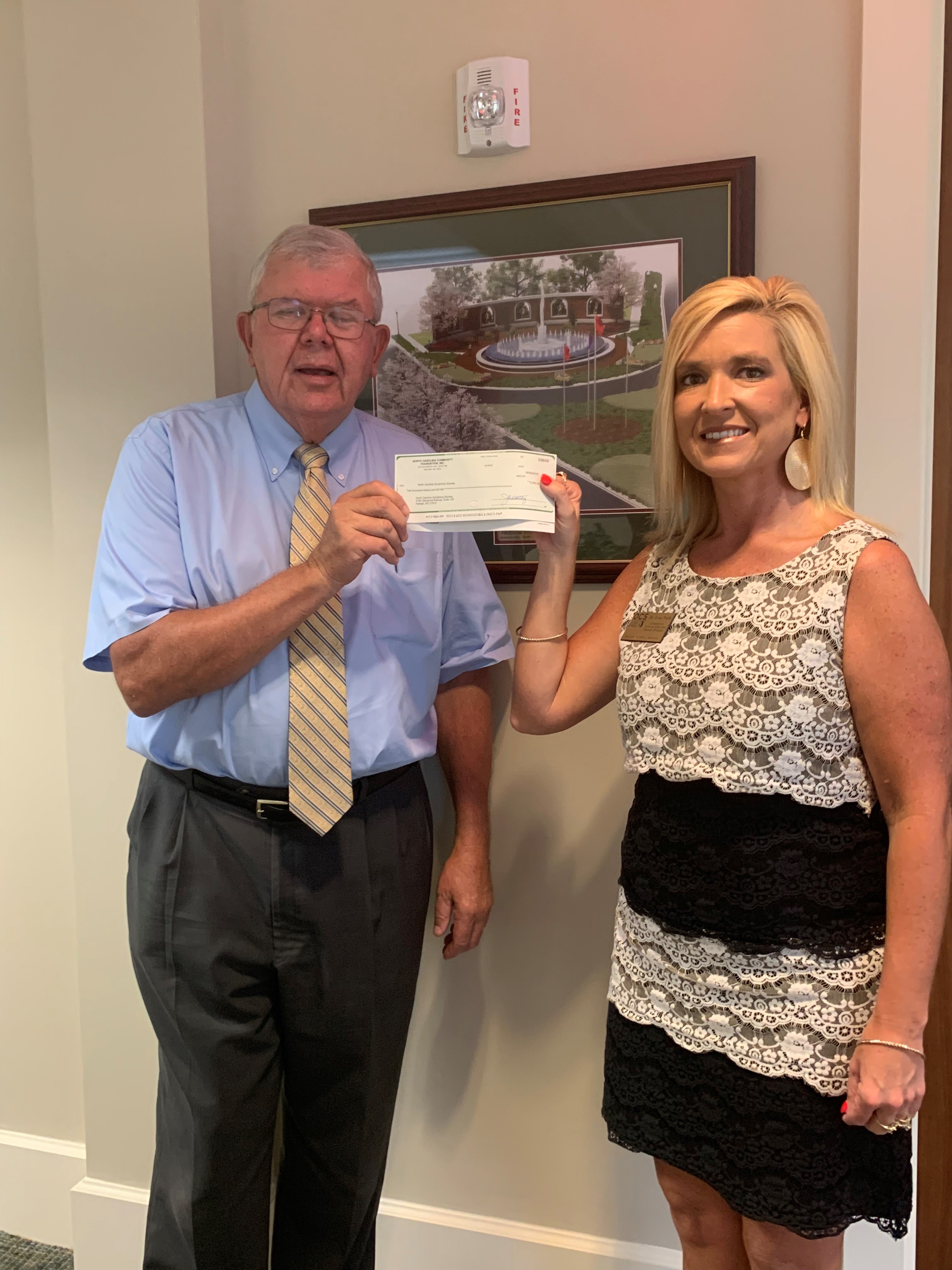 Earl Taylor, president of the Onslow County Board for the NC Symphony, with Dr. Lisa Peele, arts director and education concert coordinator of Onslow County Schools, are excited to receive grant funding from OCCF for the annual NC Symphony Education Concert.