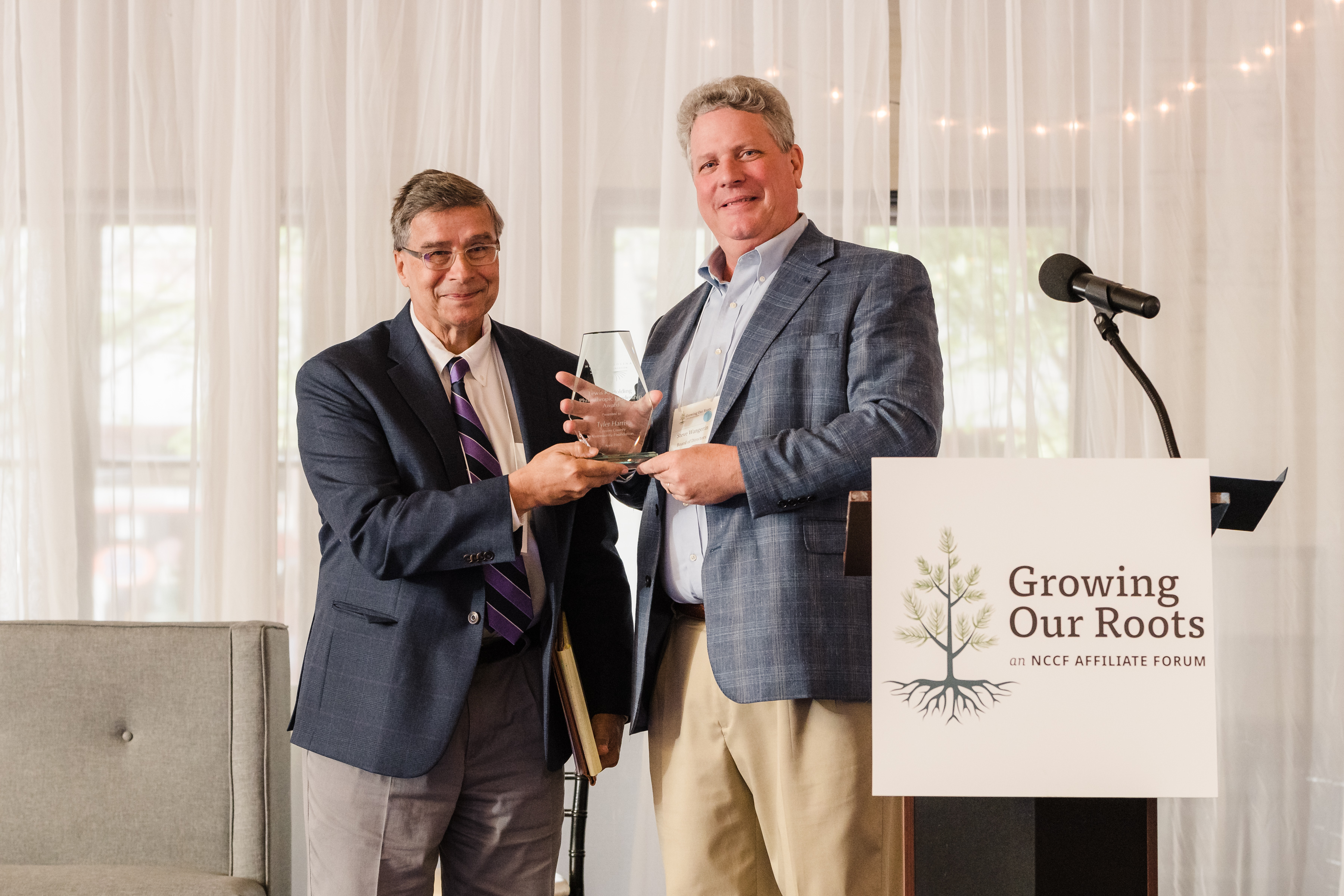 Steve Wangerin, immediate past NCCF board chair, presented Tyler Harris with the 2023 Lewis R. Holding Philanthropic Leadership Award.