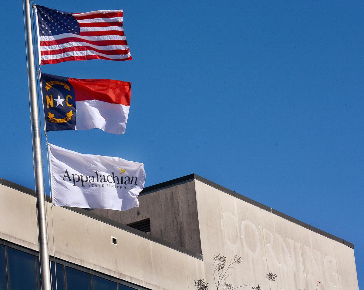 The Appalachian State University flag now flies over the site of the former Corning Optical Communications headquarters, which the university has purchased with the aim of turning it into an academic building.  Photo by Robert C. Reed, Hickory Daily Record