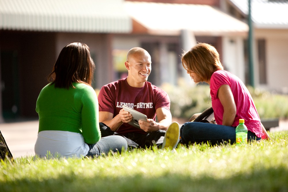 Lenoir-Rhyne University students take a break on the lawn outside the student center.