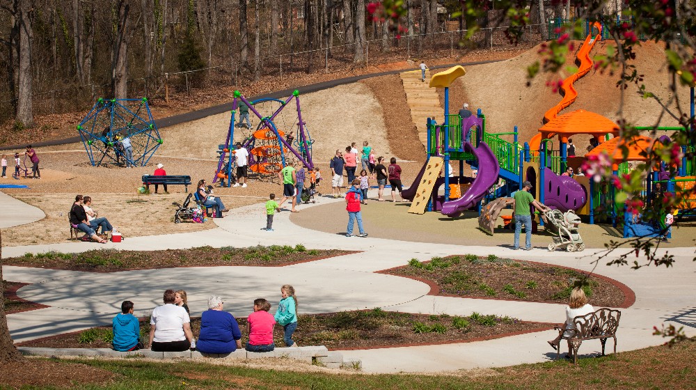 Families enjoy the afternoon at the Zahra Baker All Children's Playground. - Photo by Eckard Photographic