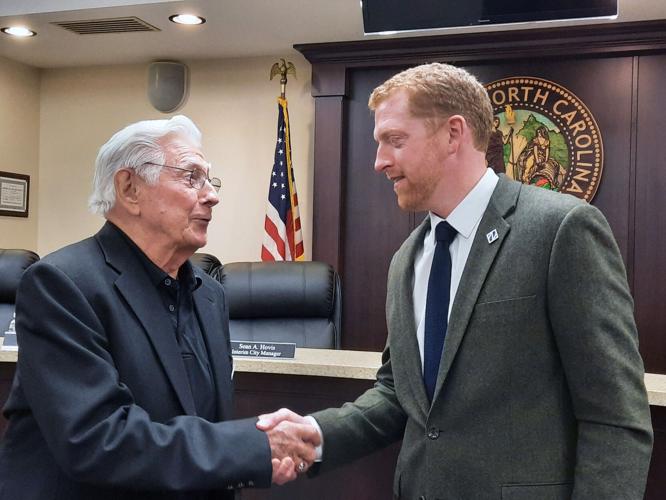 Newton Mayor Eddie Haupt, left, shakes hands with Jonathan Franklin, the city council's pick for Newton's new city manager.  Photo by Sarah C. Johnson, Hickory Daily Record