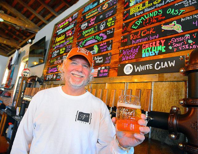 Jeff Allen, owner Novel Taproom in Newton, displays one of the numerous beers that he serves at his establishment. Photo by Robert C. Reed, Hickory Daily Record