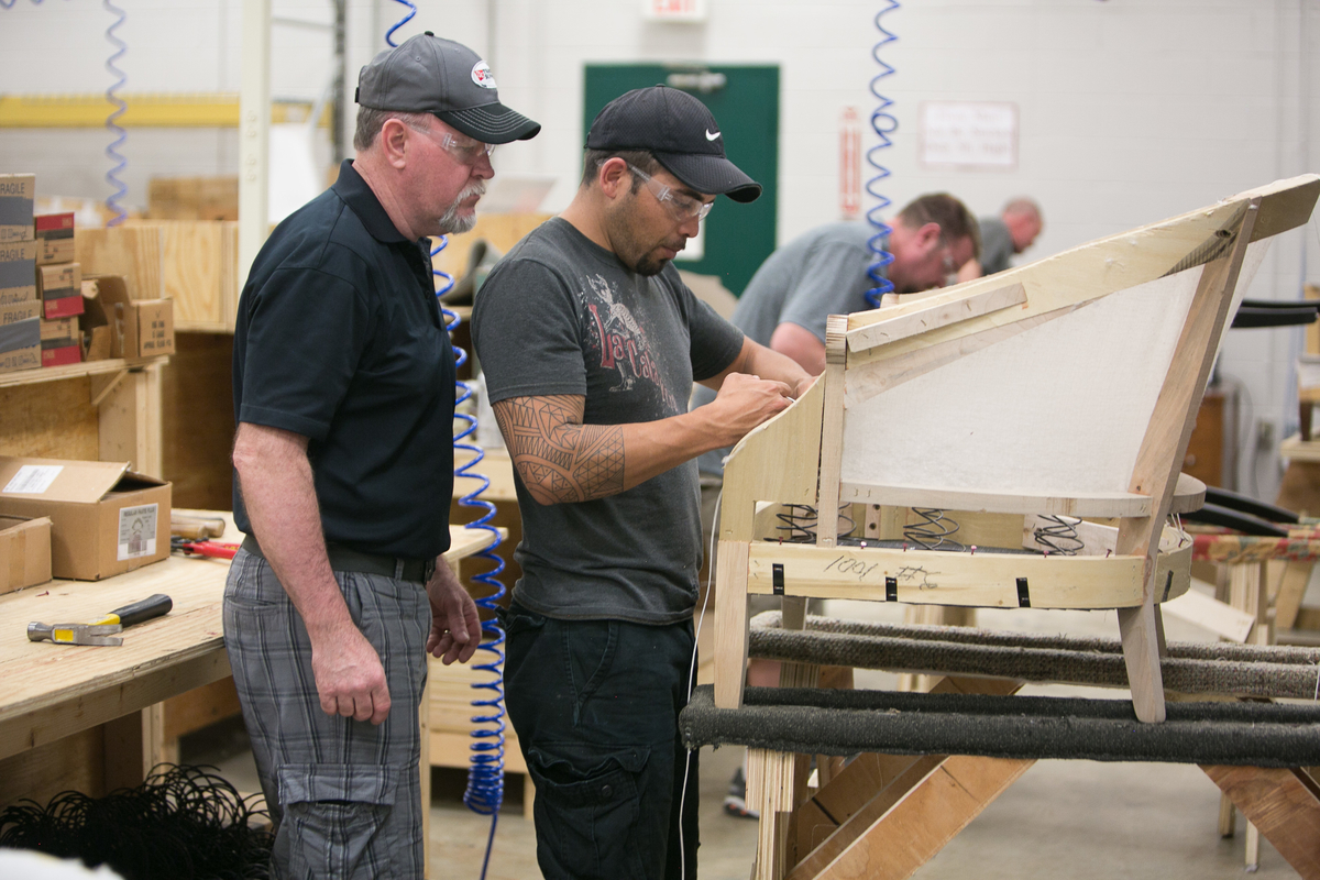 An instructor guides a student CVCC's Furniture Academy.