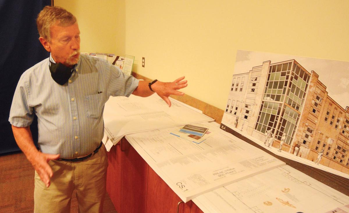 Manufacturing Solutions Center Special Projects Director Tony Whitener shows off a rendering of the new building that will be constructed near the existing building.  Photo by Robert C. Reed, Hickory Daily Record