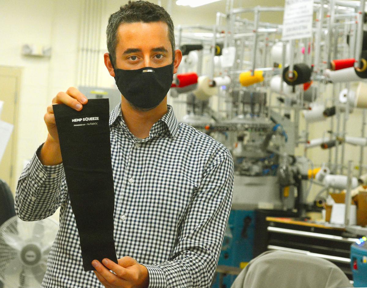 Jordan Schindler, founder and CEO of Nufabrx, displays an arm sleeve his company manufactured in this file photo from May of last year. The company pivoted to making masks from the same material in 2020.  Photo - ROBERT C. REED, RECORD